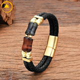 alt="Bracelet homme en cuir tressé noir avec pierres œil de faucon bleu-gris et œil de taureau rouge, fermoir doré"
