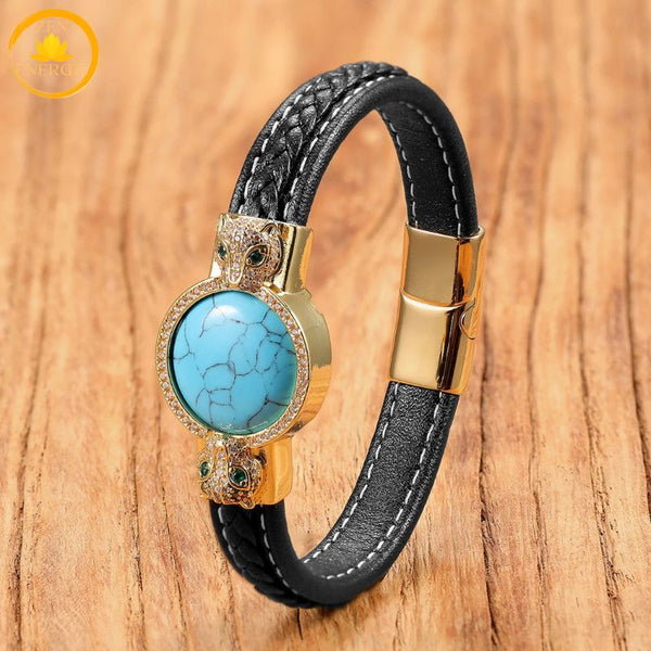 alt="Bracelet en cuir noir avec pierre naturelle turquoise Mohave et fermoir doré motif tête de loup"
